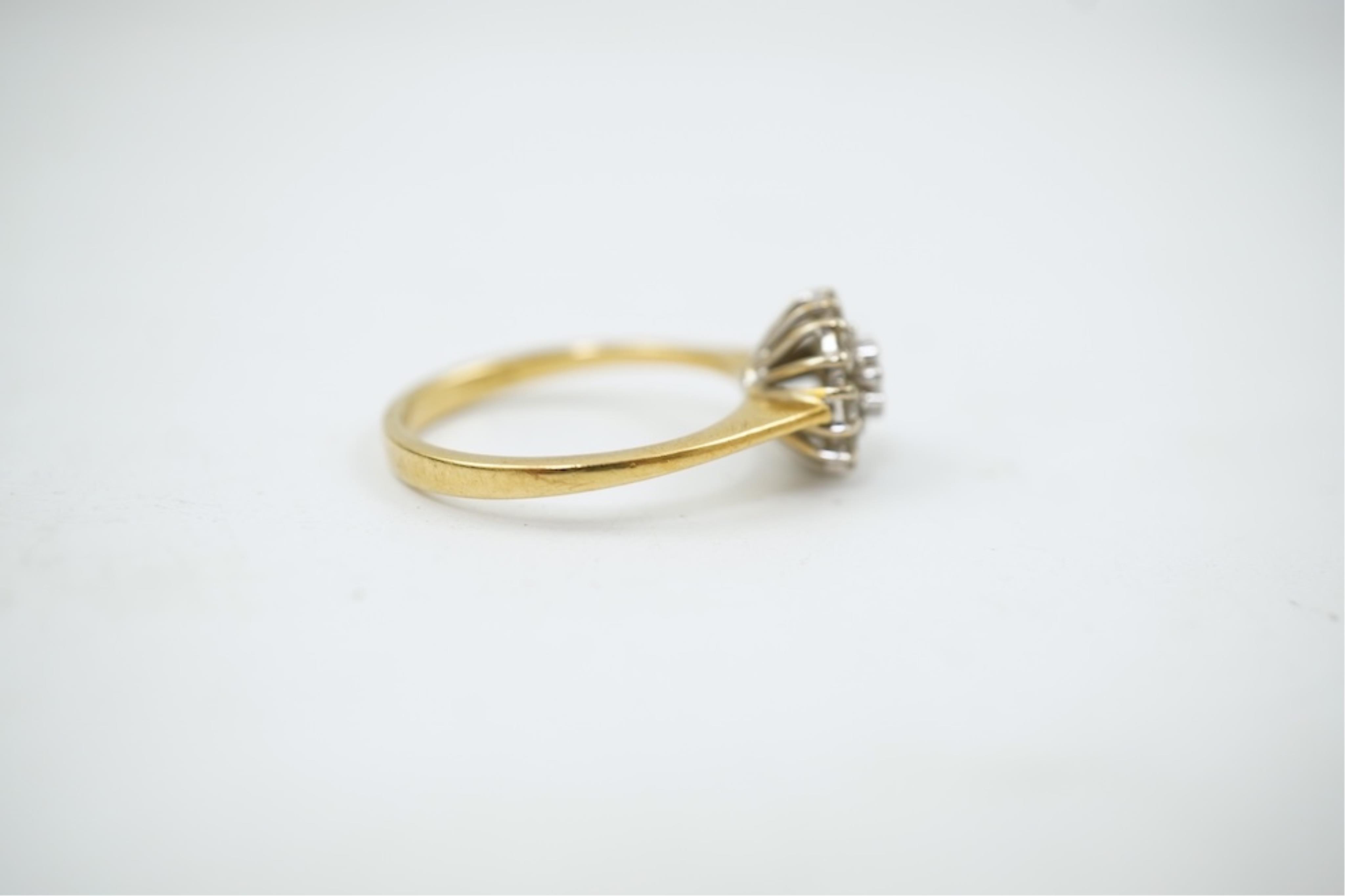A modern 18ct gold and diamond set circular cluster ring, size M, gross weight 3.2 grams.